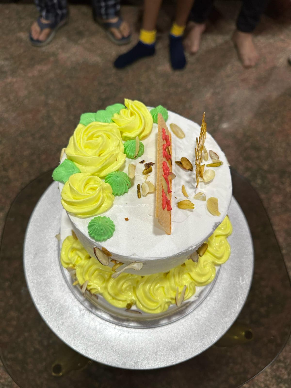 A themed tiered cake decorated for a first birthday